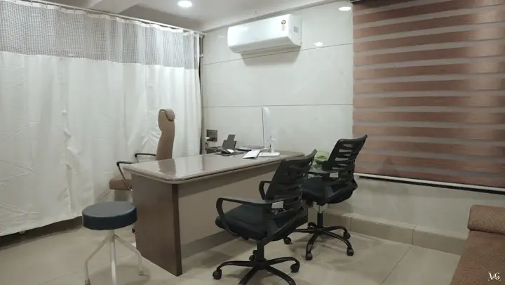 Doctor's consultation room with desk and chairs